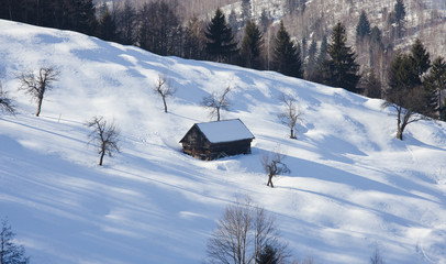 old house in winter mountain landscape