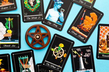 Tarot Deck - Tarot Readings with wooden pentagram incense burner on blue background