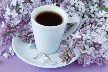 Romantic background with cup of tea, lilac flowers