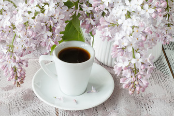 The beautiful fresh lilac violet flowers on a wooden background. Close up of lilac blossoms. Spring flower, twig lilac