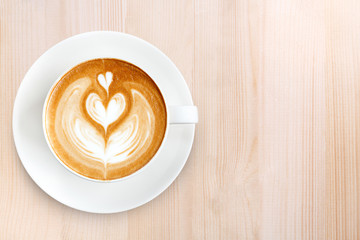 Top view latte art coffee on wood background