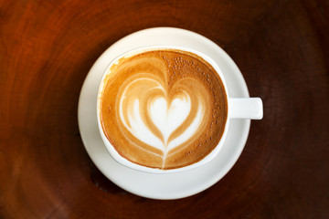 Coffee latte art in coffee shop in vintage color filter