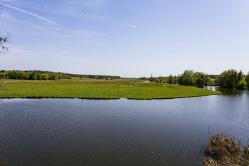 green grass with a river on background
