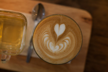 Coffee latte art in coffee shop in vintage color filter