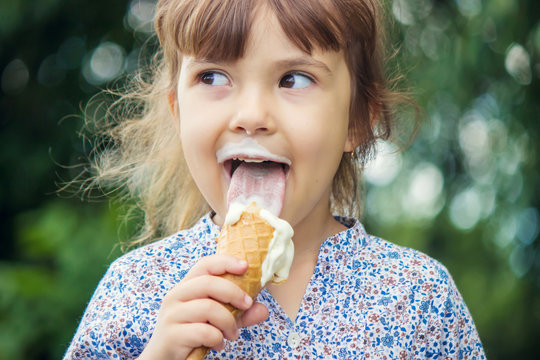 The Child Eats Ice Cream. Selective Focus. 