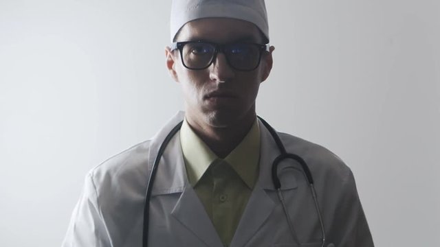 Angry Doctor girl showing fuck. Medical worker shows the middle finger.
