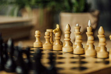 Old chess board set for a new game on the table. Selective focus on white chess pieces