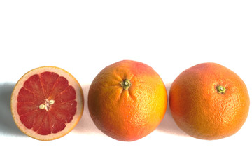Closeup of red grapefruits on a white background