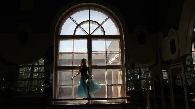 Silhouette of ballet dancer in ballet hall