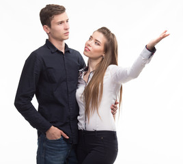 Young happy couple showing presentation pointing on placard over