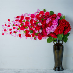 Rose petals speckled fall on the floor. Wooden background