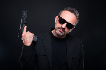 Killer man with pistol on dark background