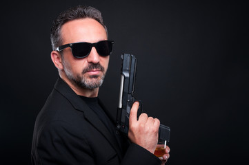 Mafia member holding a gun or pistol