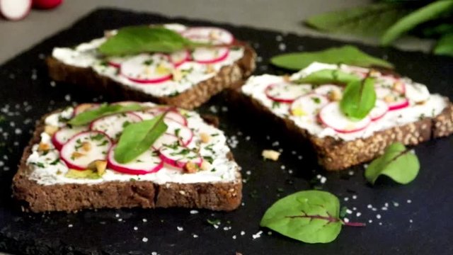 Delicious sandwiches with soft cream cheese and radish. Vegetarian food.