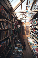 Fototapeta na wymiar Full-length shot of young woman in library