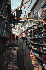 Naklejka premium Portrait of a stylish young woman choosing book