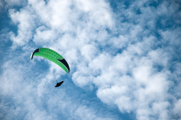 Paraglider flies paraglider in the sky. Paragliding.