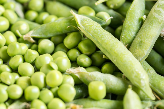 Pile of fresh green peas closeup macro view above