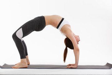 Fototapeta na wymiar Young woman exercise yoga supported headstand