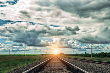 Railway at sunset with dramatic sky. Railroad track. Close up view.