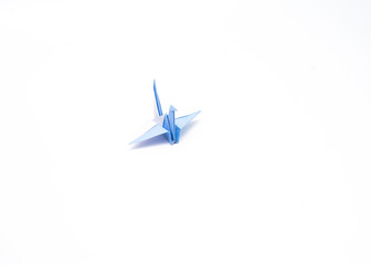 Blue origami bird isolated with white backround