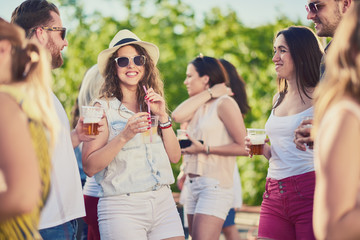 Group of people smiling, drinking, laughing and having a good time at the party