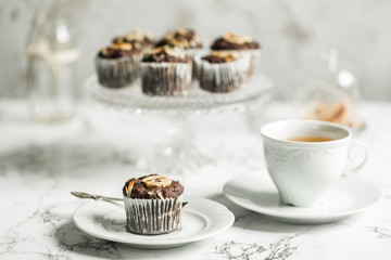 Chocolate muffins with banana and tea