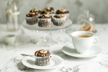 Chocolate muffins with banana and tea