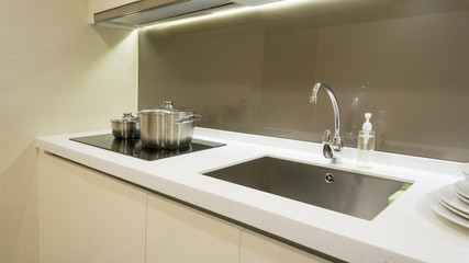 Arranged kitchen pot and kitchen sink on kitchen cabinet - 159574323