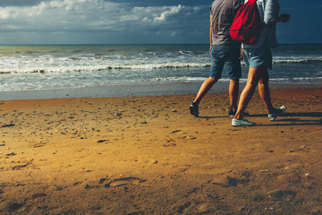 Young Couple Walking Along Beach Walking Together Concept Rear View