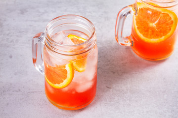 Campari and vermouth cocktail with oranges, garnished with thyme