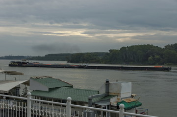 Obraz premium Pass tug-boat along pontoon and boats in the Vidin Danube port, Bulgaria, Europe 