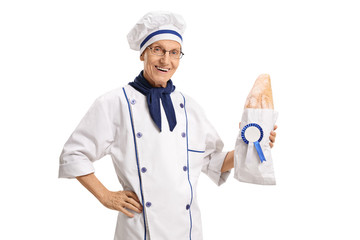 Baker holding a loaf of bread with an award ribbon