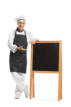 Full length portrait of a chef showing a blank blackboard