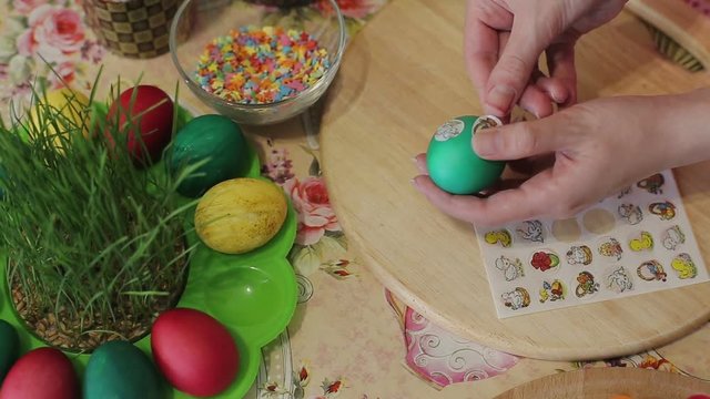 Girl decorates Easter eggs