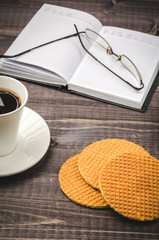 book, coffee and wafers on a wooden background/Waffles on a wooden table