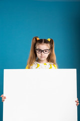 Little dark hair girl in glasses with board