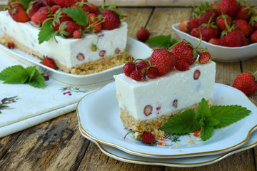 Delicious cheesecake with berries, bio homemade strawberries from garden, delicious and simple cake on wooden background. Copy space for your text