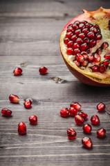 ripe fruit of pomegranate and grain/ripe fruit of pomegranate and grain on a wooden background