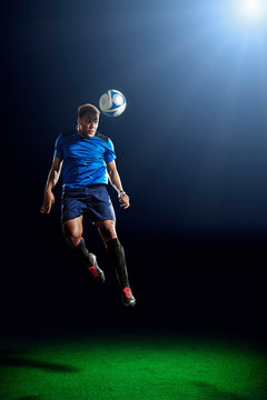 Male soccer player heading ball