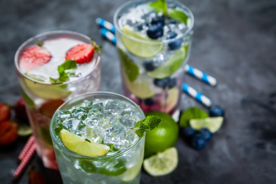 Selection of colorful mojitoes in glasses