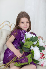 Portrait of girl in purple dress with white peonies