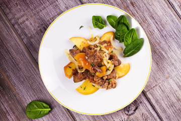 Chicken liver with apple, spinach and onion. View from above, top studio shot