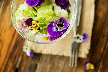 Close up salad leaves garden herbs and edible flowers. Healthy nutrition. Food background