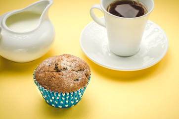 tasty cupcake on a background a cup and a creamer/tasty cake on a background a white cup and a creamer