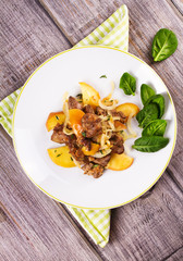 Chicken liver with apple, spinach and onion. View from above, top studio shot