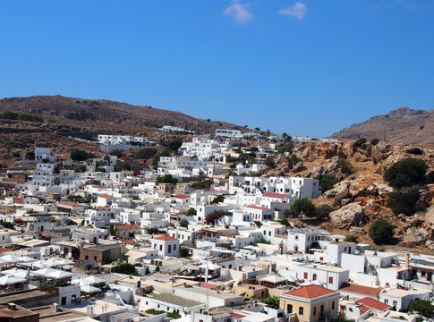 arial panoramic view of afandou village in rhodes with blue sky and mountains