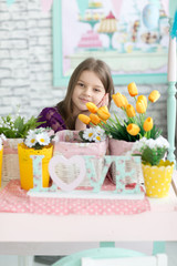 Portrait of sweet girl in purple dress with flowers