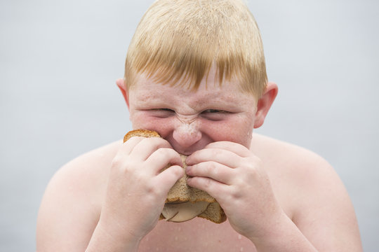 Portrait of boy eating sandwich