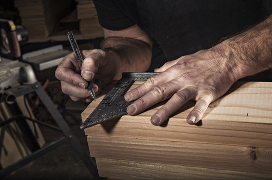Close up of male carpenter using set square in workshop